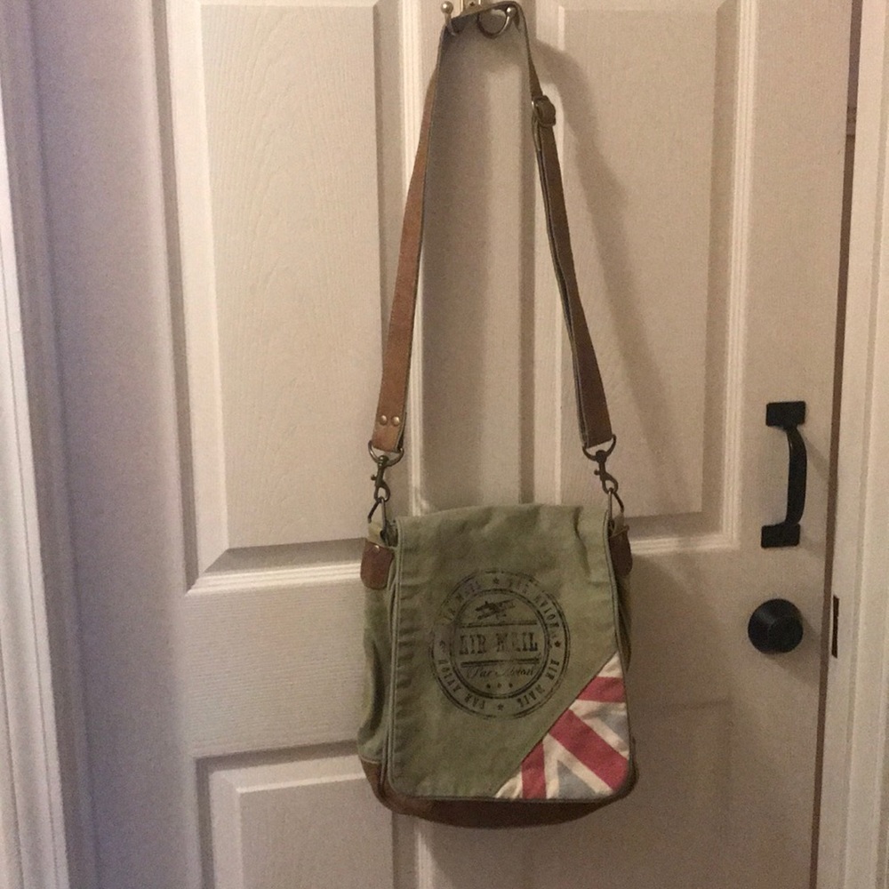 Tan in color and brown leather bottom and handle